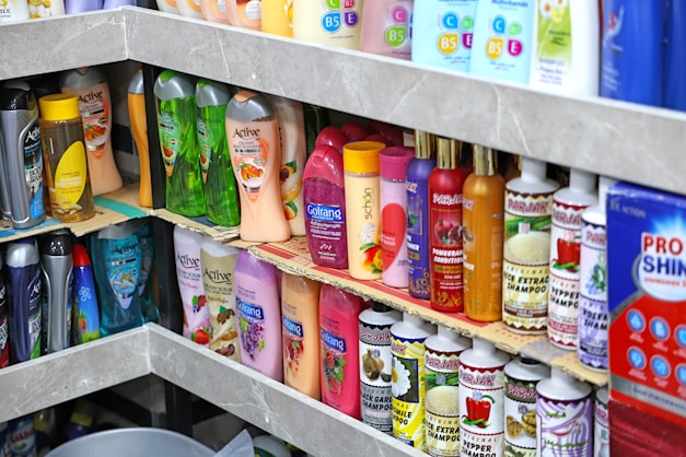 Shelves stocked with shampoo, conditioner, and personal hygiene products