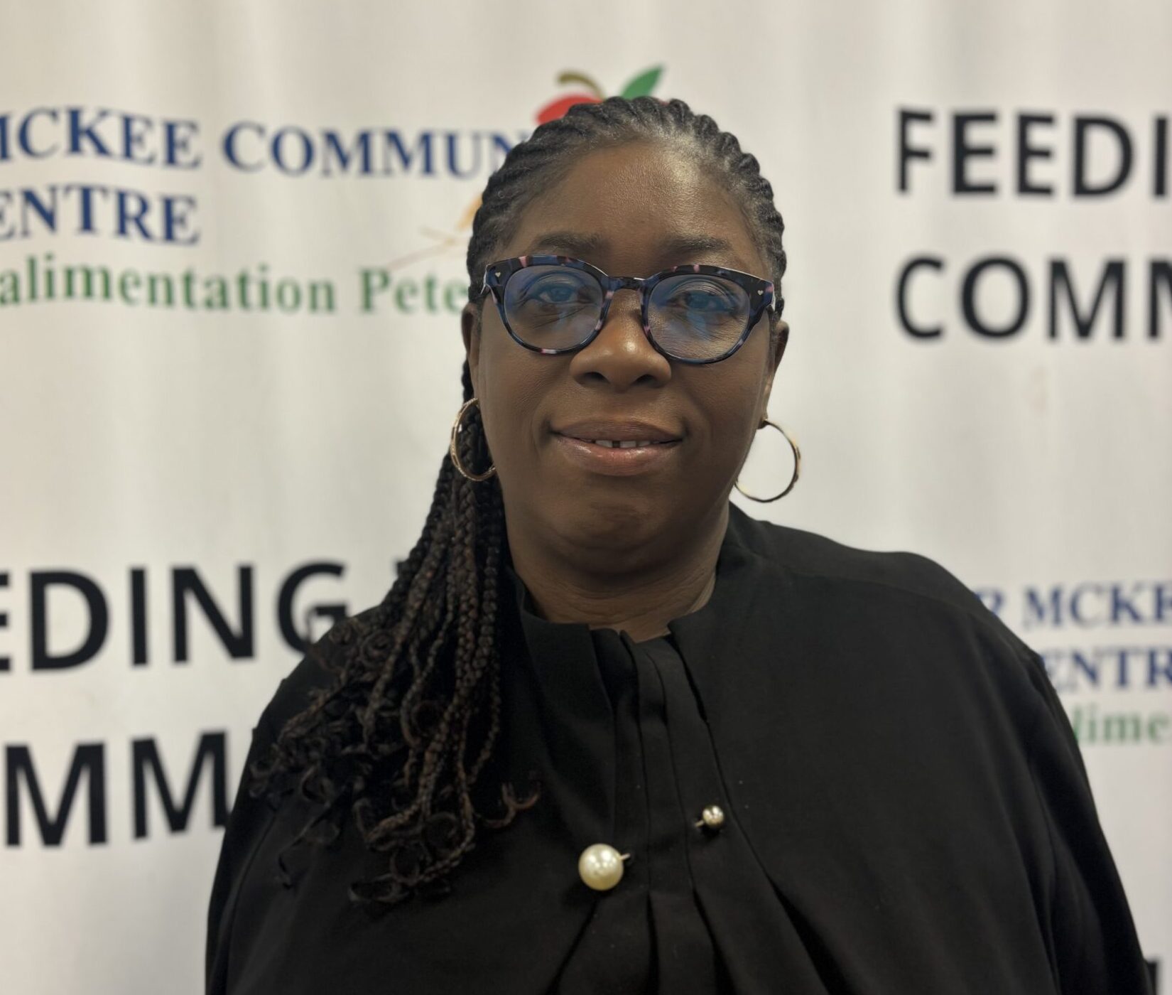 Portrait of a Peter McKee Community Centre team member wearing glasses
