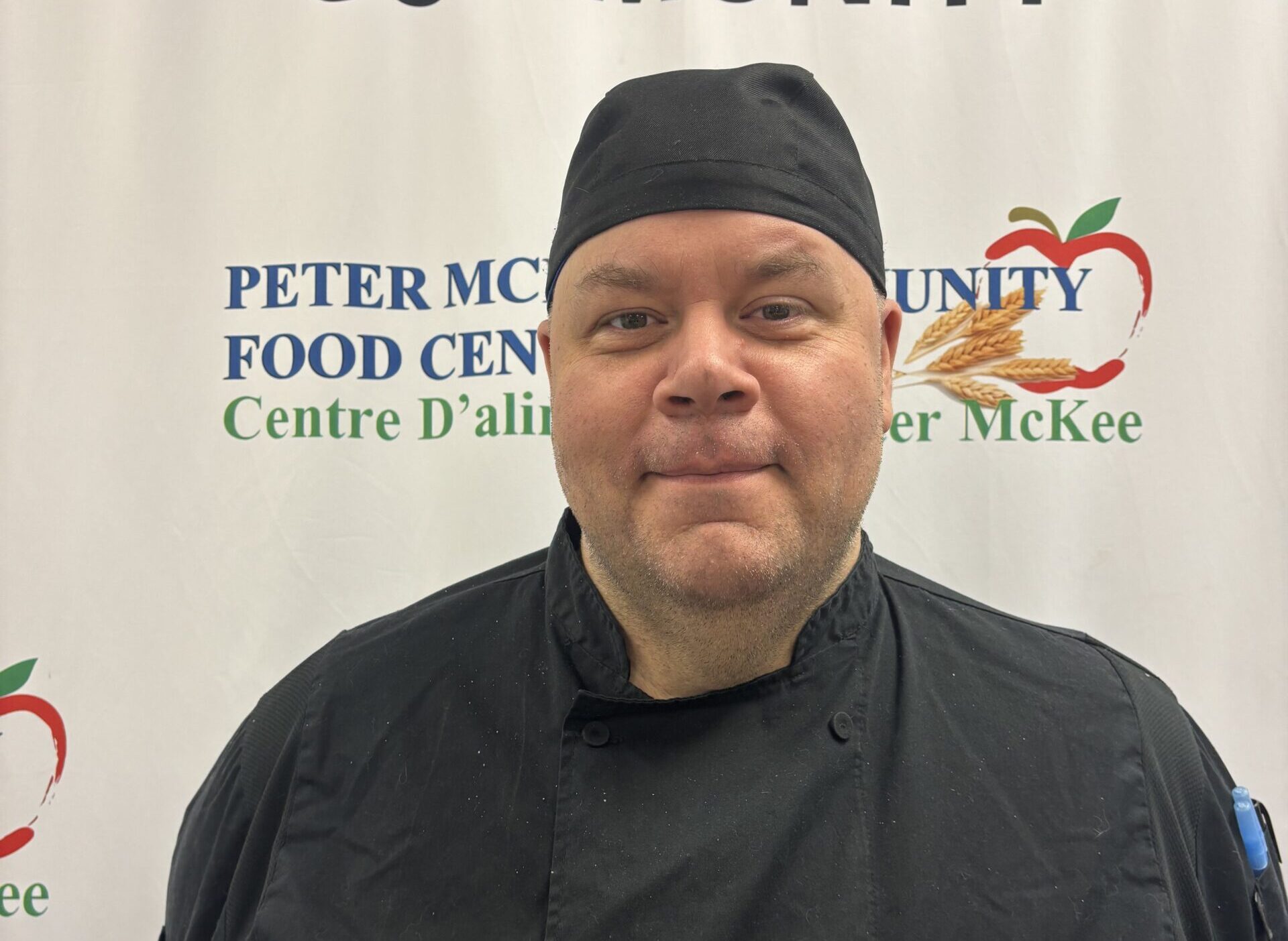 Portrait of a Peter McKee Community Centre kitchen team member in a chef uniform