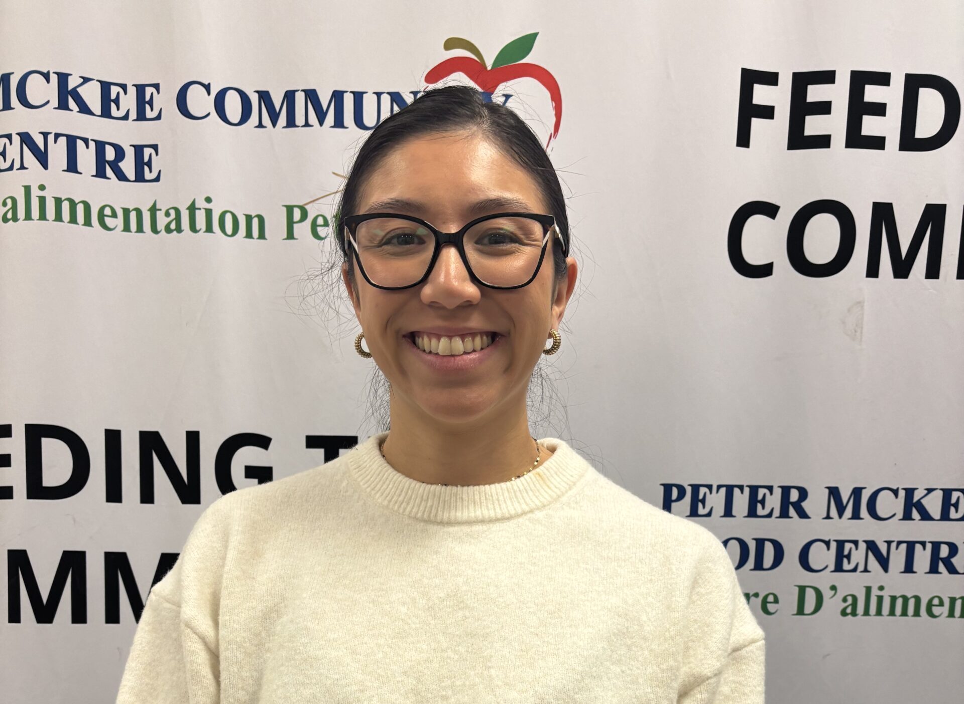Portrait of a Peter McKee Community Centre team member wearing glasses and a sweater